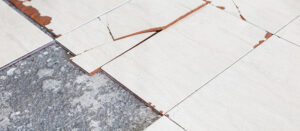 broken tile before dustless floor removal by Floor Busters of Central Florida. 